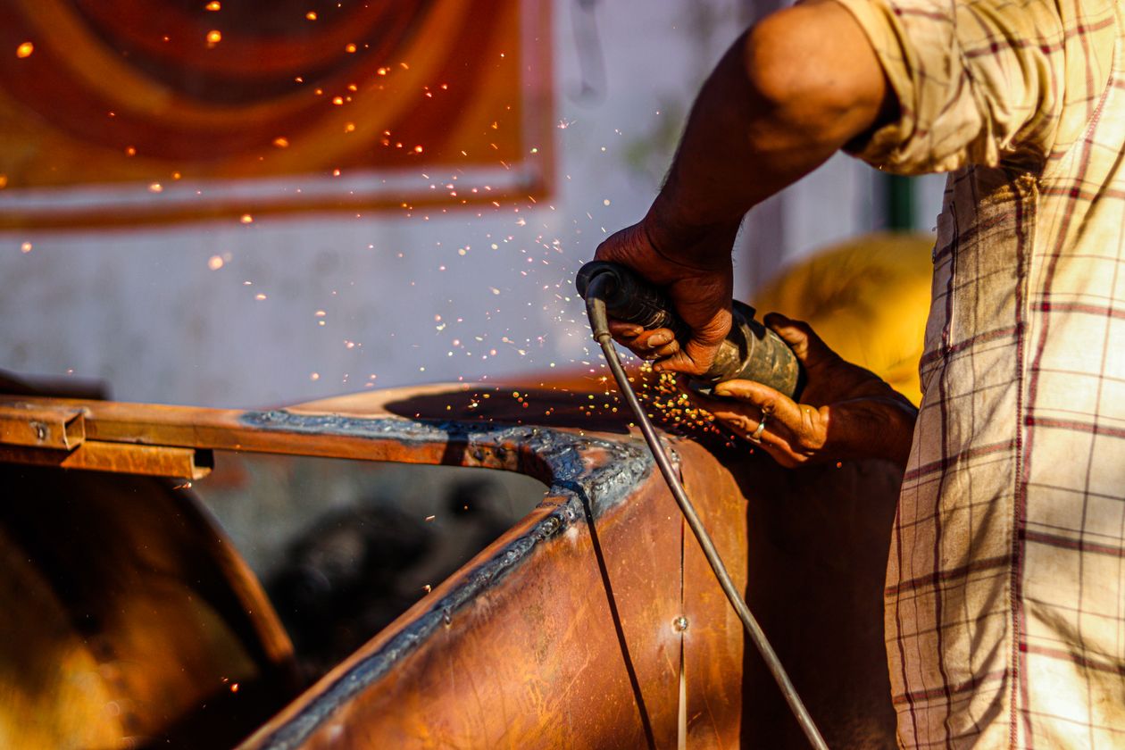 Construction worker using an angle grinder that creates respirable silica dust