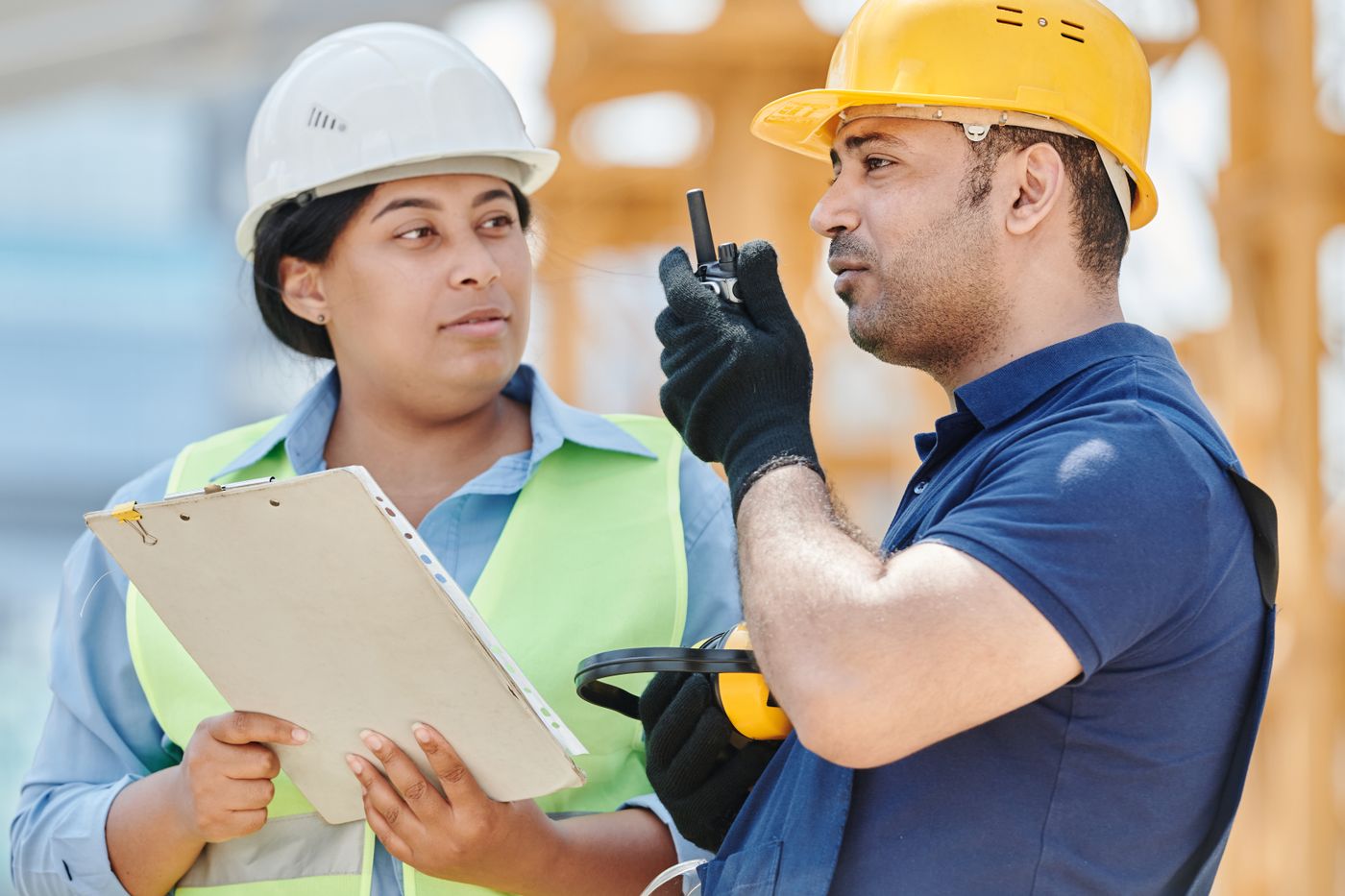 Two workers going through accident investigation steps during a witness interview on a construction site