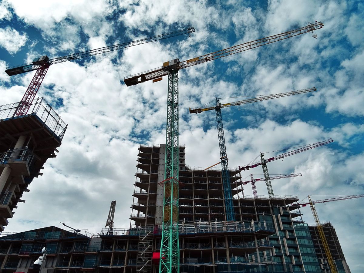 Tower cranes working over a high-rise construction site